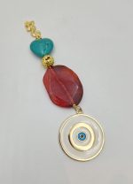Charm with agate, haolite, gilded lava and enamel eye