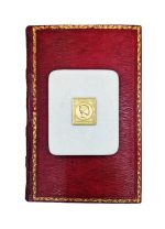 Gilded copy of a stamp with Hermes head on a marble base.